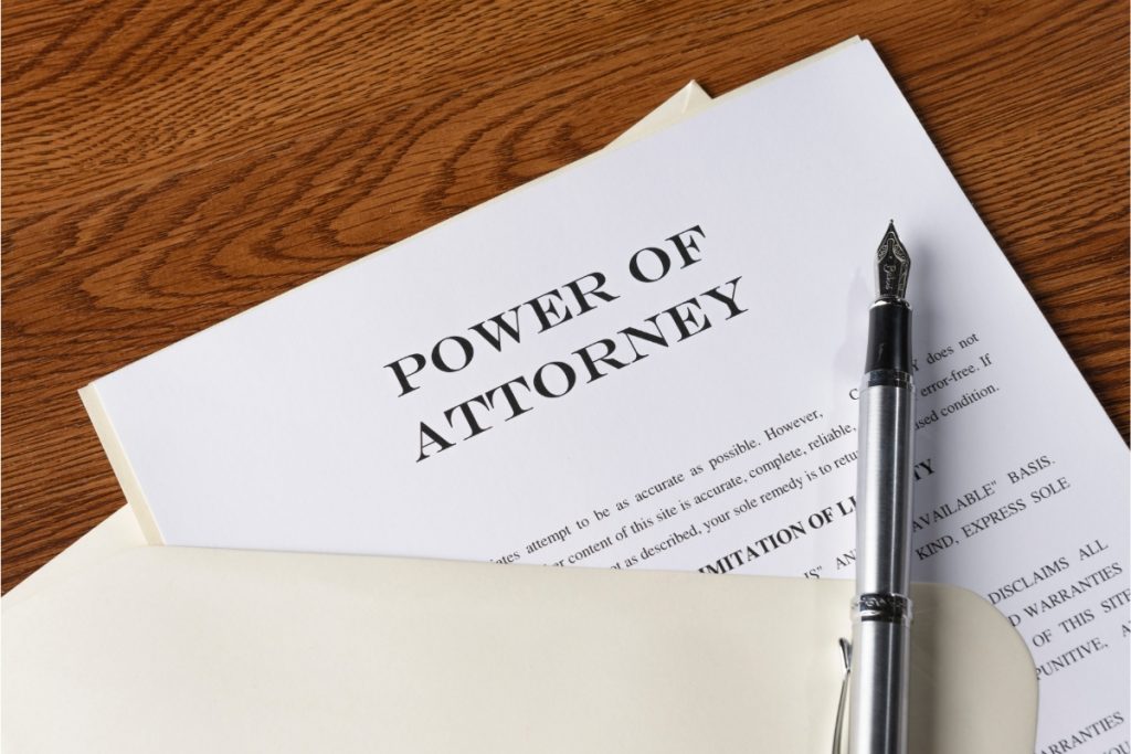 Power of Attorney documents on a table with a pen and manilla folder
