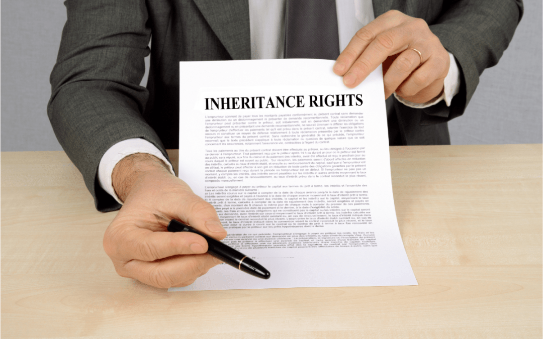 close up of a man in a business suit showing where to sign on a document that says "Inheritance Rights"