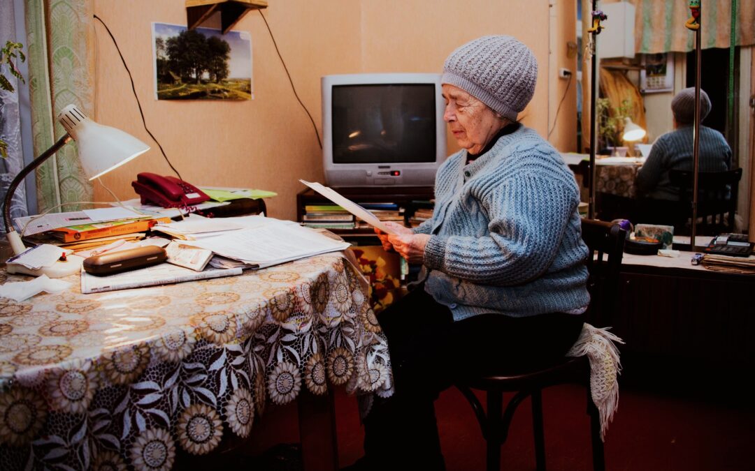 An elderly woman considering voluntary conservatorship while looking at her bills